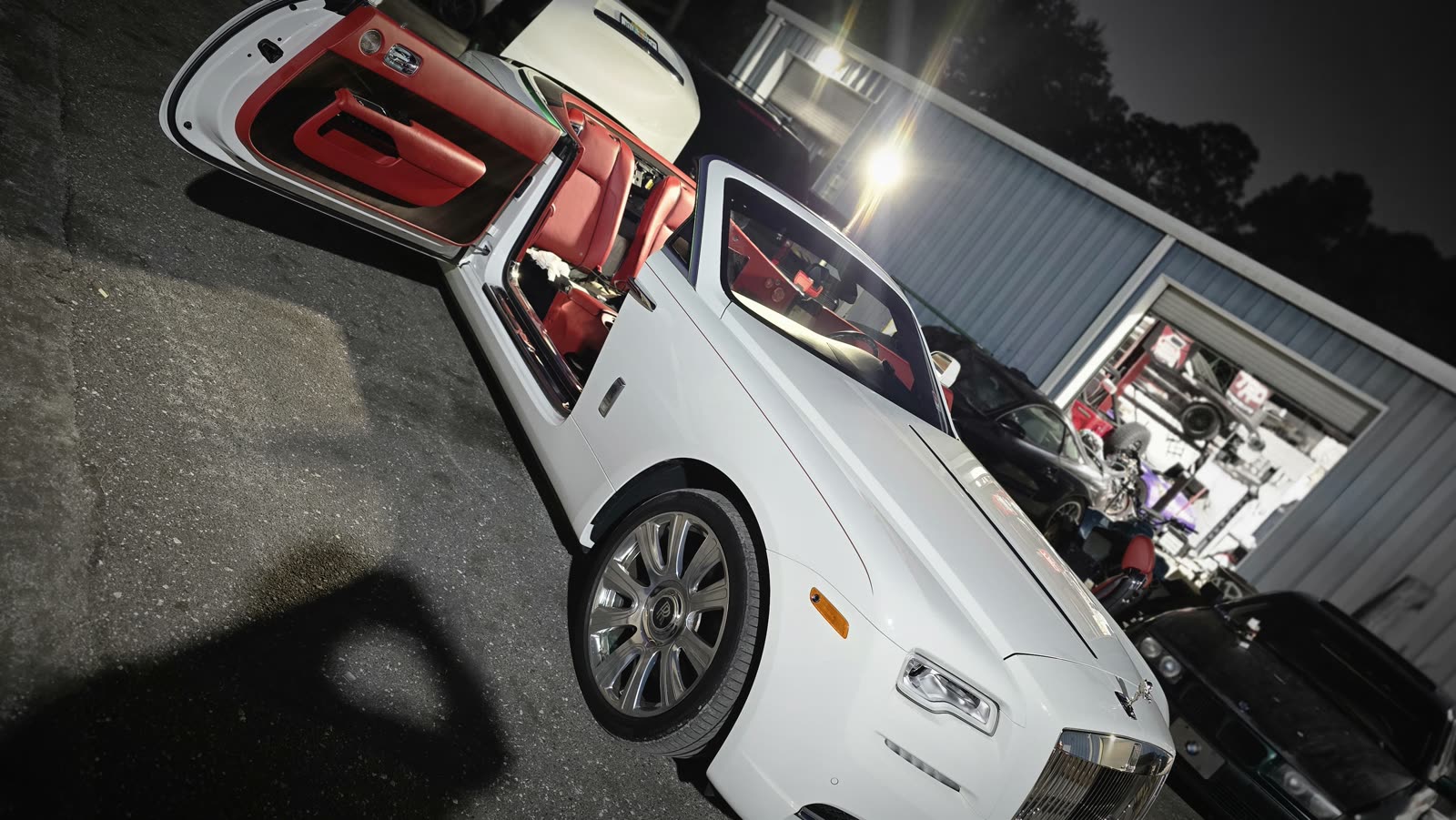 Rolls-Royce Dawn with the doors open at night